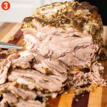 Sliced pork shoulder on a cutting board.