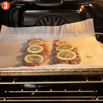 Red snapper on a baking tray in the oven.