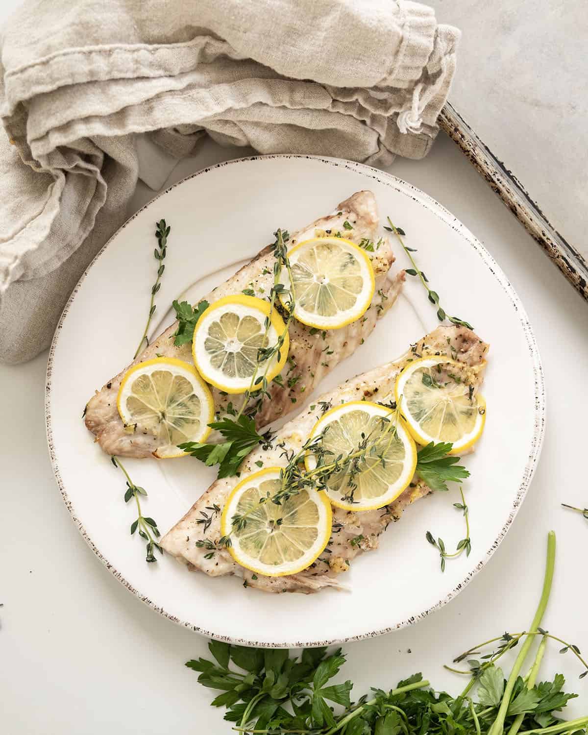 Baked red snapper topped with lemon and thyme.