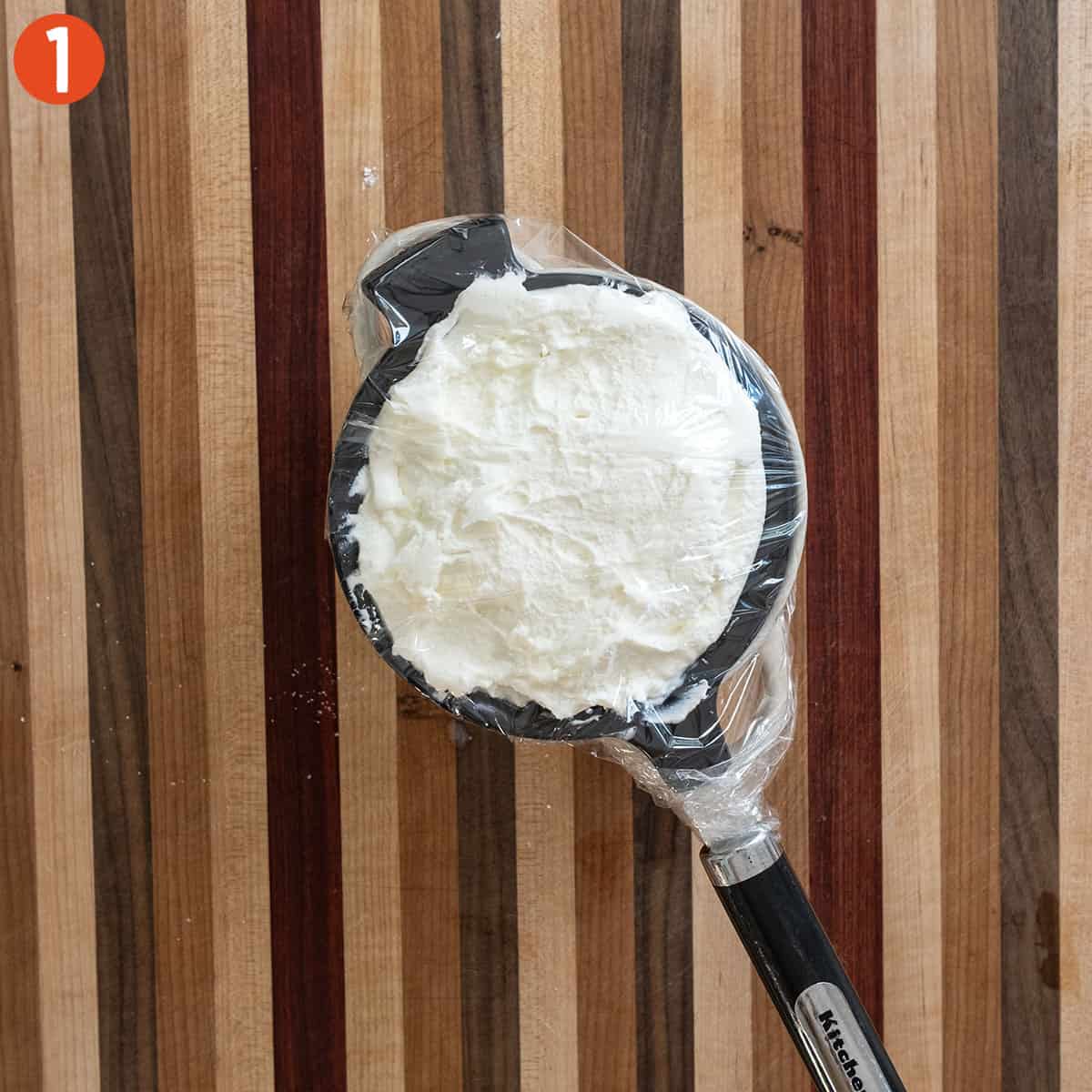 Draining ricotta in a mesh strainer.