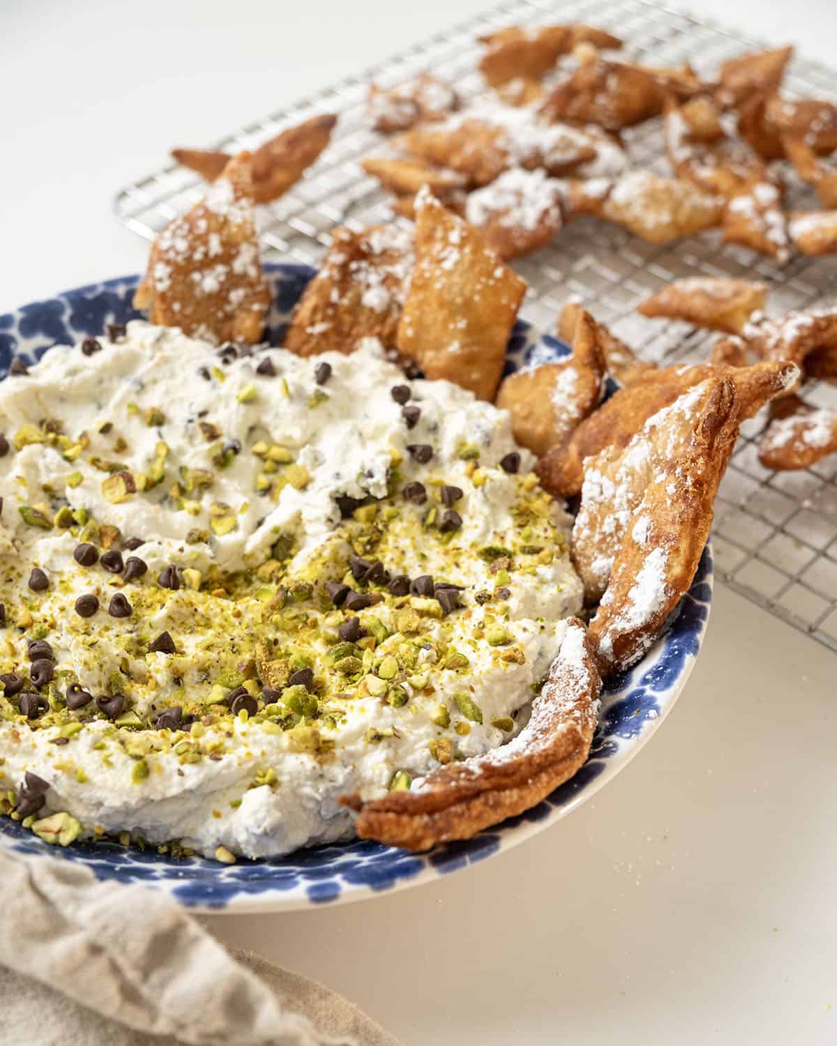 Homemade cannoli dip and chips in a dish.