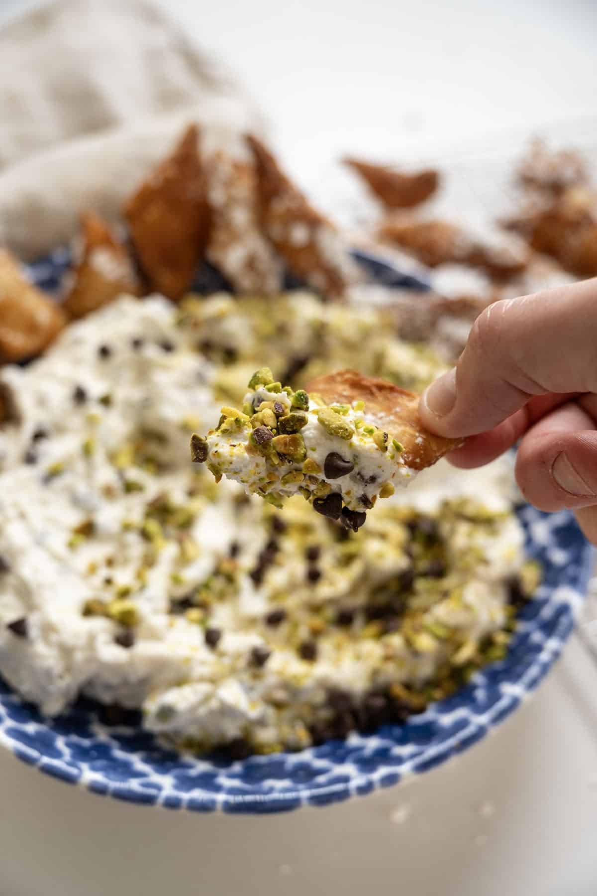 Homemade cannoli dip and chips in a dish.