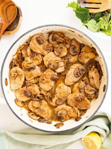 Pork tenderloin medallions in marsala sauce in a braiser.