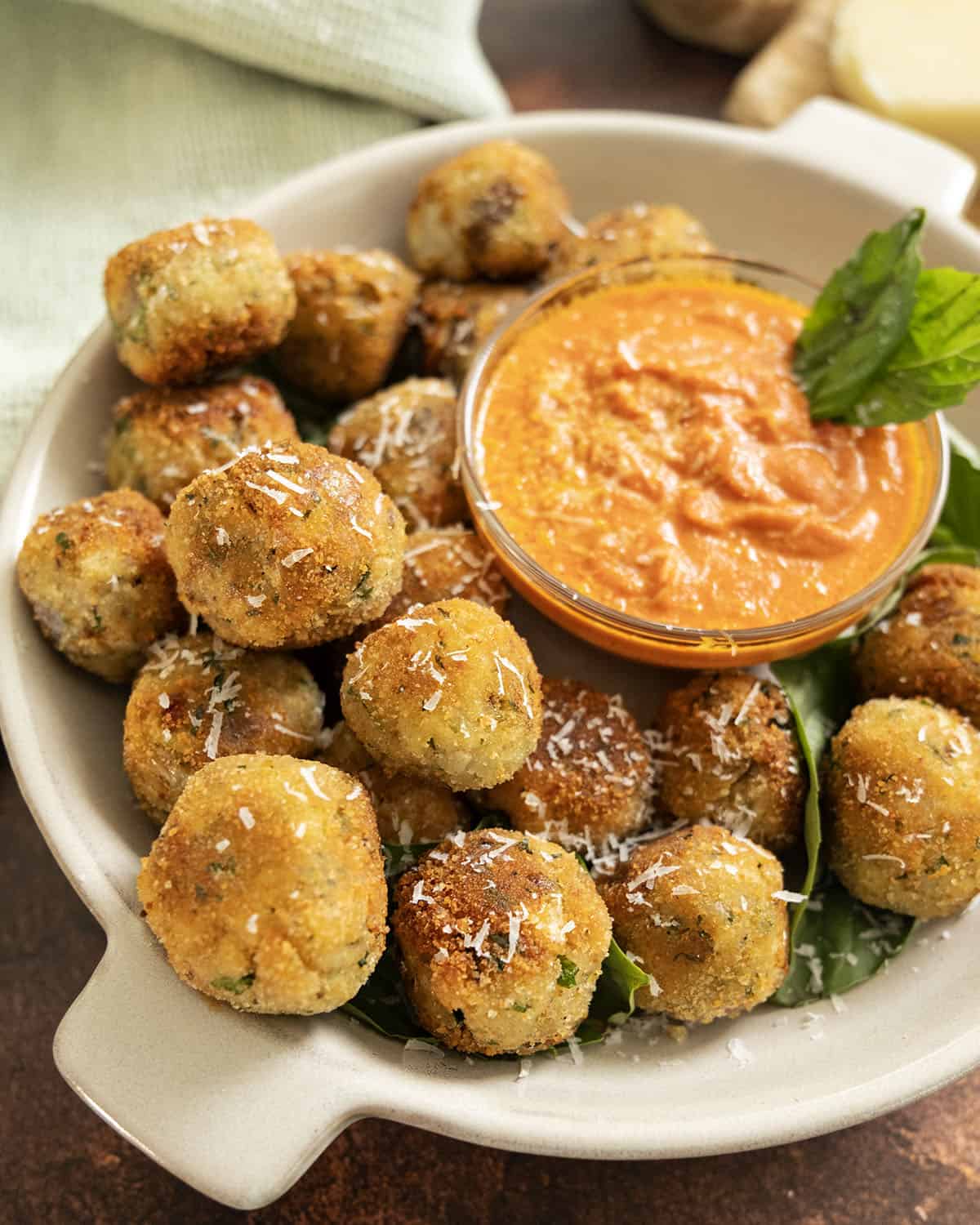 Polpette di Melanzane or eggplant meatballs in a bowl with sauce.
