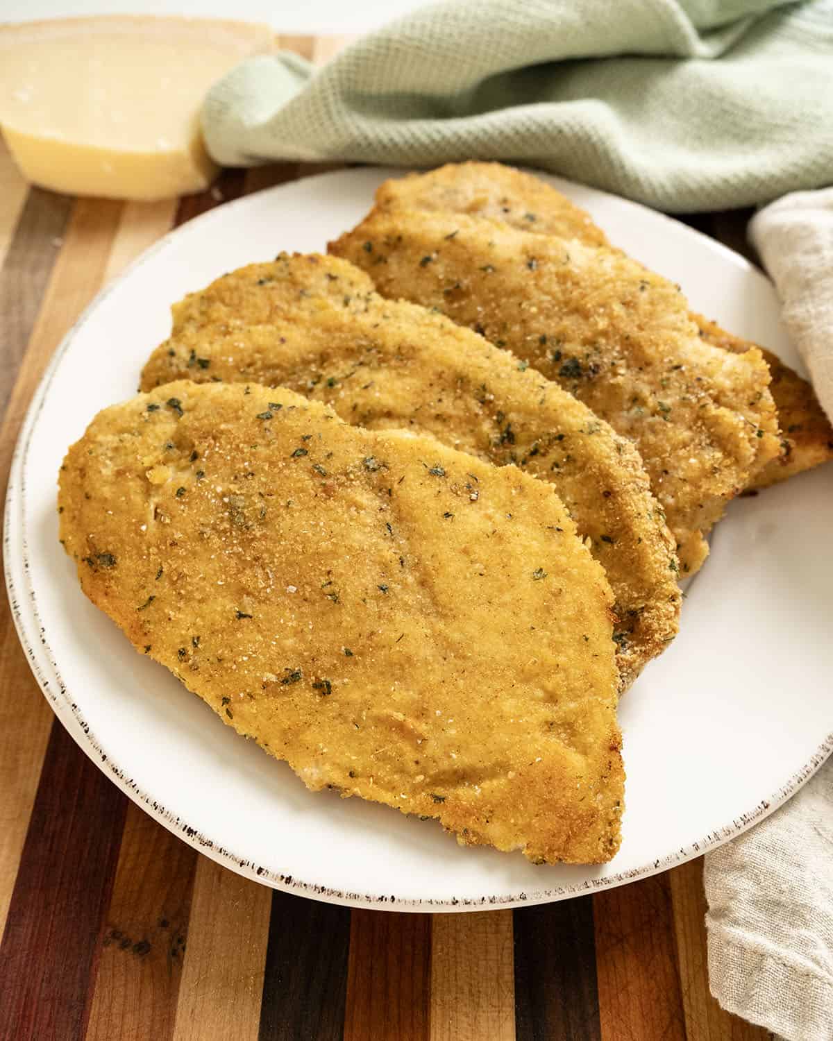 Oven baked chicken cutlets on a plate.