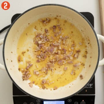 Sauteing shallots in a pan.