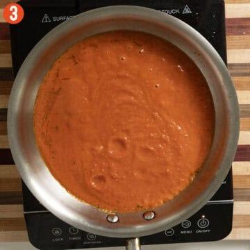 Simmering marinara sauce in a pan.