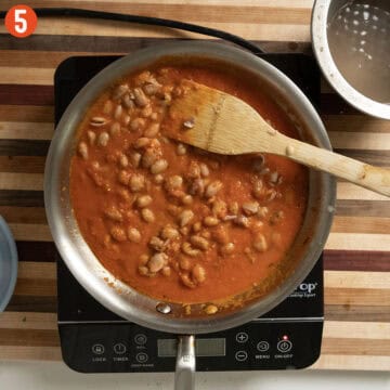 Simmering beans with marinara sauce.