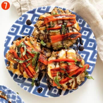 Baked stuffed mushrooms topped with roasted red peppers, basil, and balsamic glaze.