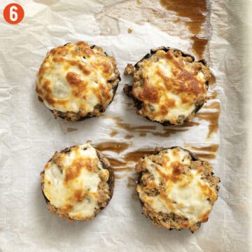 Stuffed mushrooms baked on a pan.
