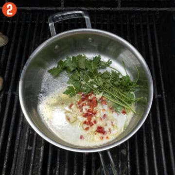 Sauteing garlic, fresno red pepper, parsley, in olive oil and butter.