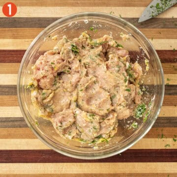 Mixing ingredients for chicken meatballs in a bowl.