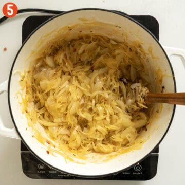 Onions and potatoes softened and caramelized in a dutch oven.