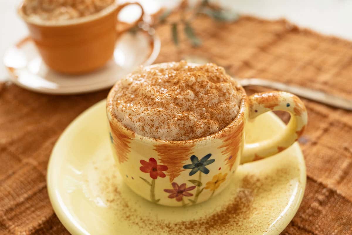 Italian rice pudding served in a cup, sprinkled with cinnamon.