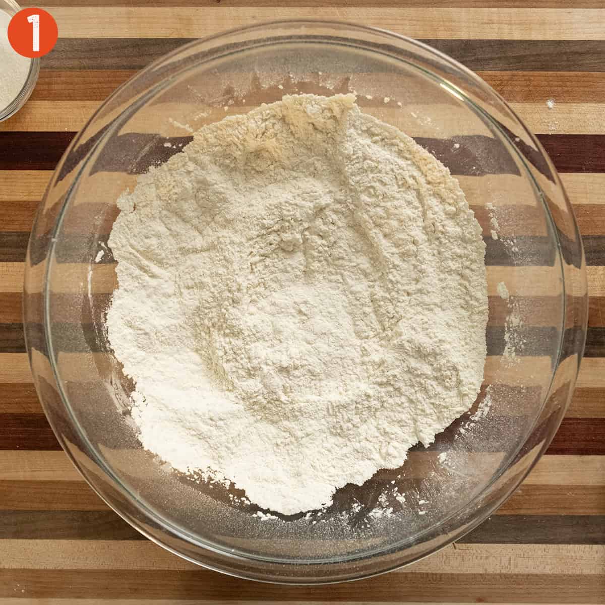 Combining dry ingredients in a bowl.