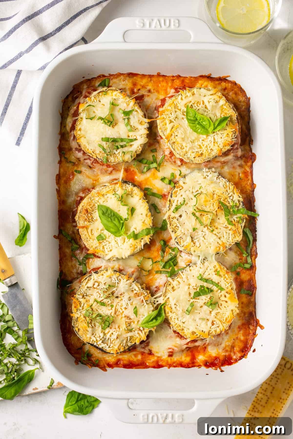 Keto Baked Eggplant Parmesan in a white Staub casserole dish