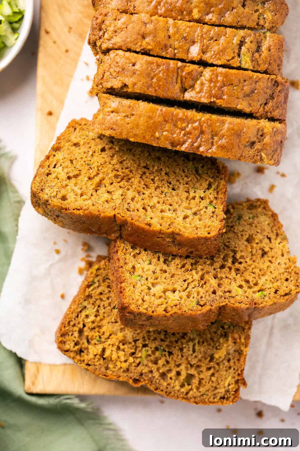 A close-up of perfectly sliced gluten free zucchini bread, showing its moist interior and delicious texture.