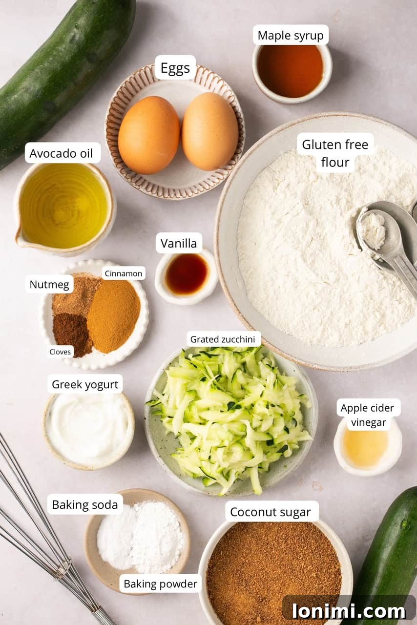 A selection of recipe ingredients, neatly arranged in nesting bowls and clearly labeled, showcasing fresh zucchini, flour, and spices.