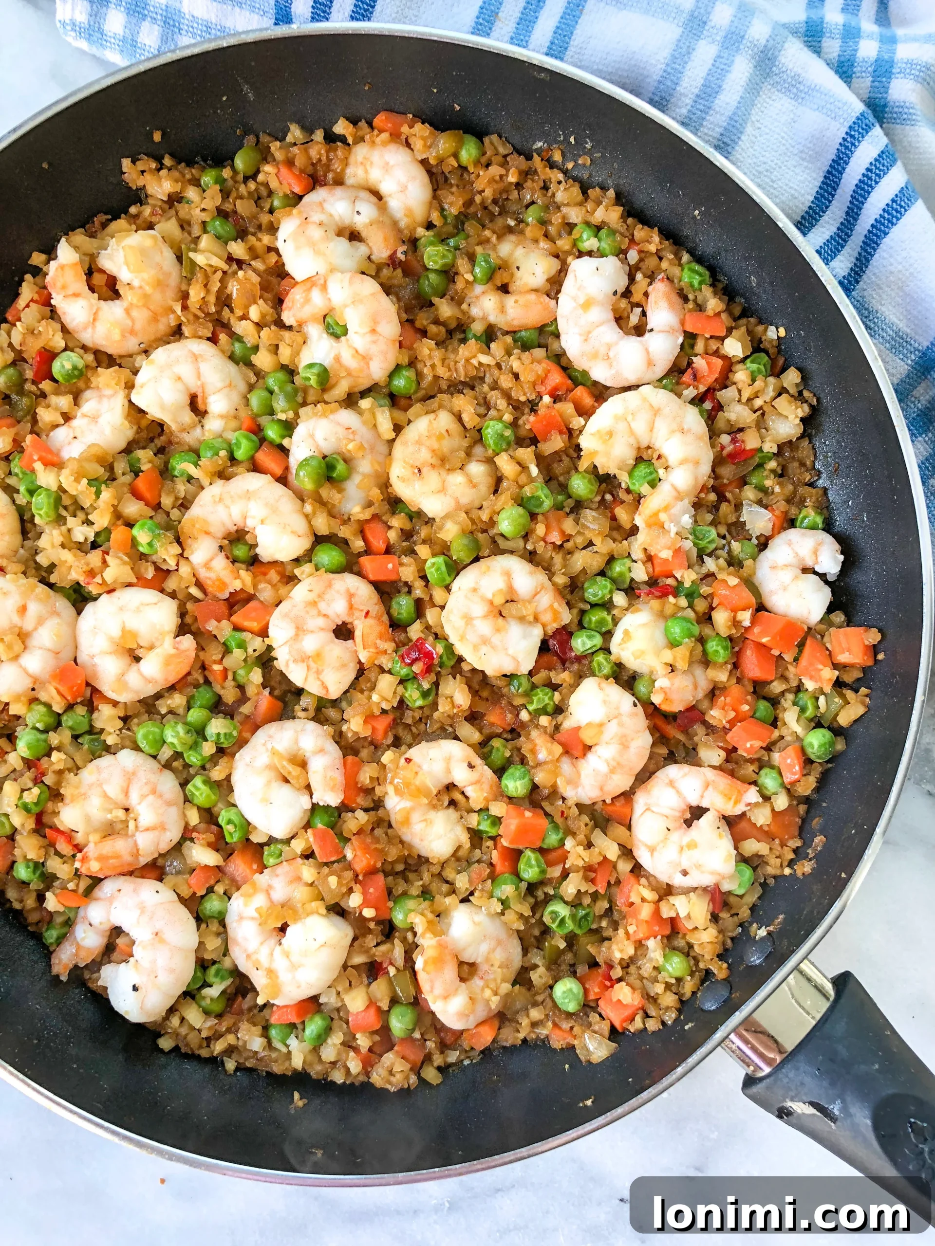Grain-Free Shrimp Stir-Fry 2 A beautifully plated dish of Paleo Shrimp Fried Rice, garnished with fresh green onions.