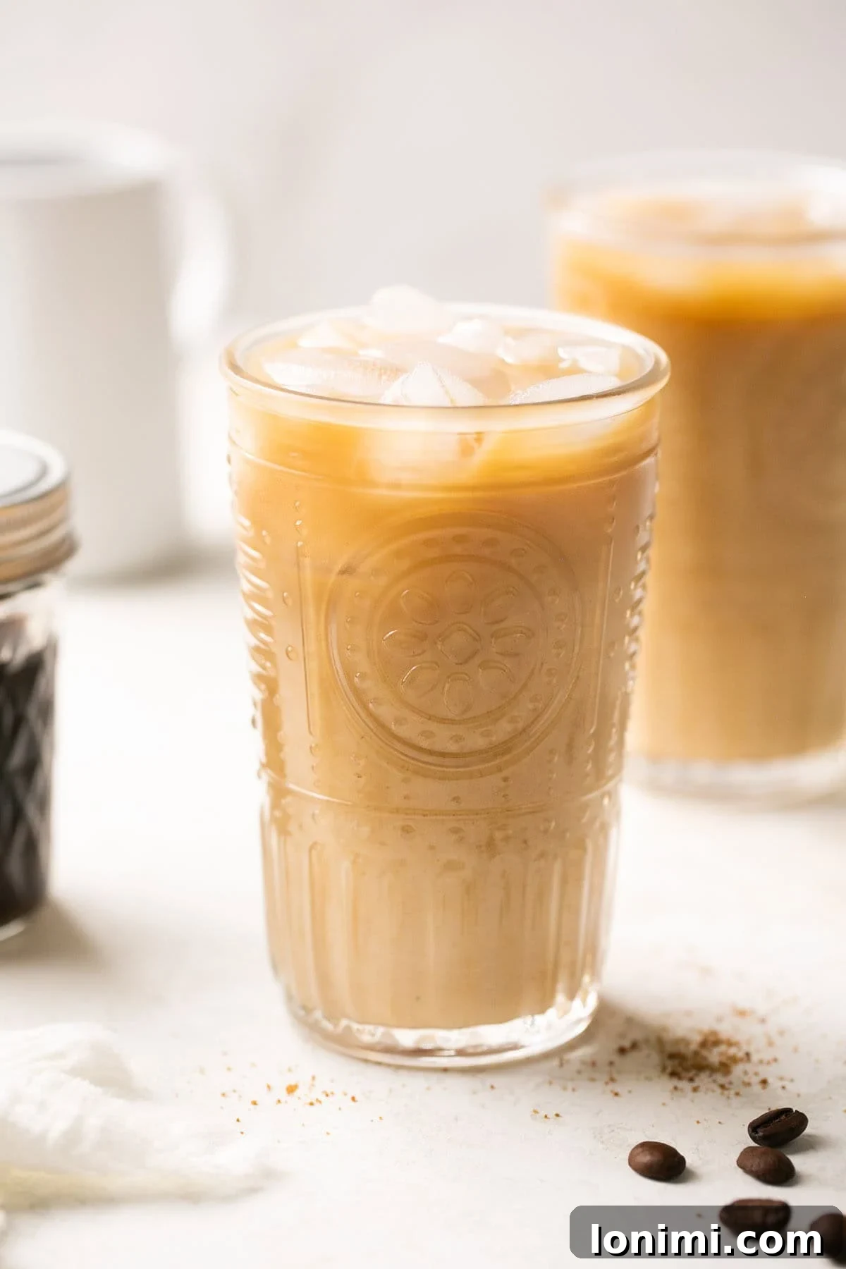 A tall glass filled with ice, espresso, and creamy oat milk, resembling a perfectly crafted brown sugar shaken espresso.