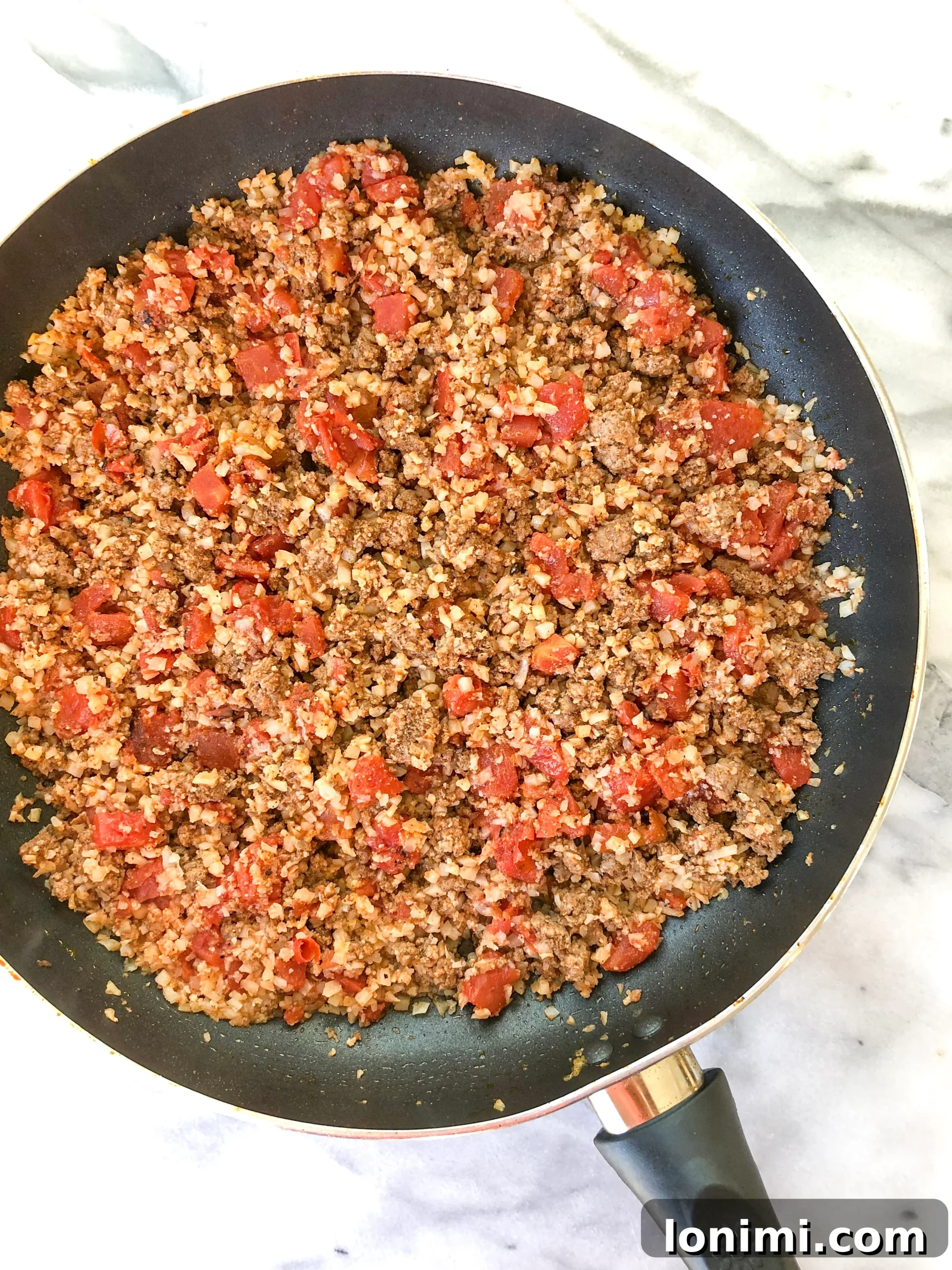 Ingredients for Whole30 Taco Skillet: ground beef, cauliflower rice, diced tomatoes with green chilis, and spices