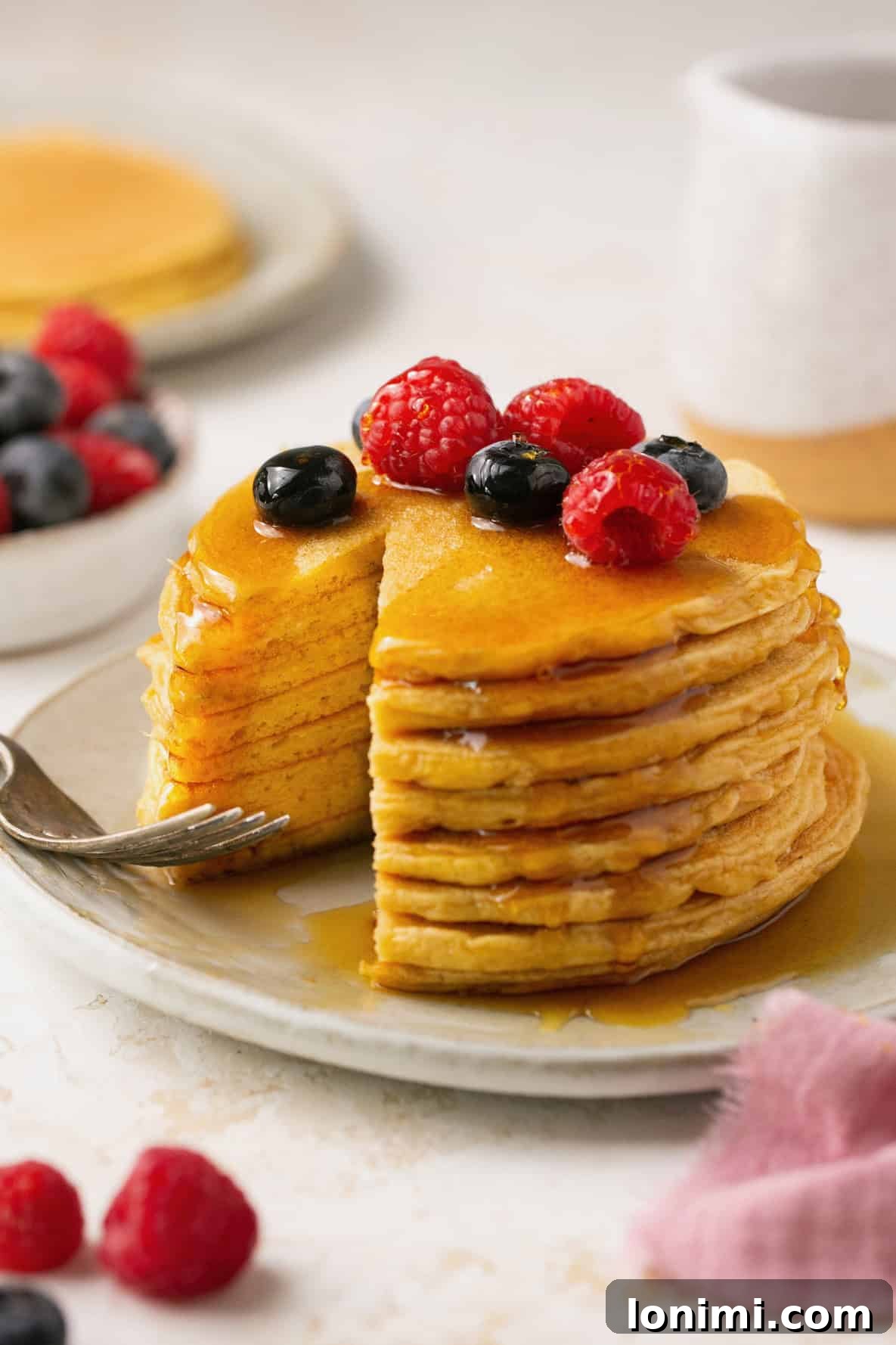 protein pancakes stacked on a plate with a bite taken out