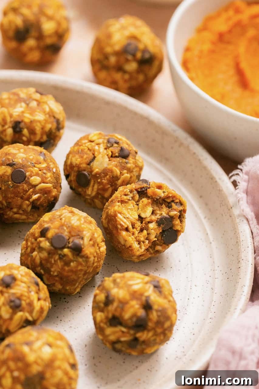 pumpkin pie bliss balls on a plate with a bite taken out