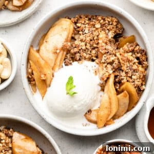Paleo Apple Crisp in a white owl with ice cream and mint
