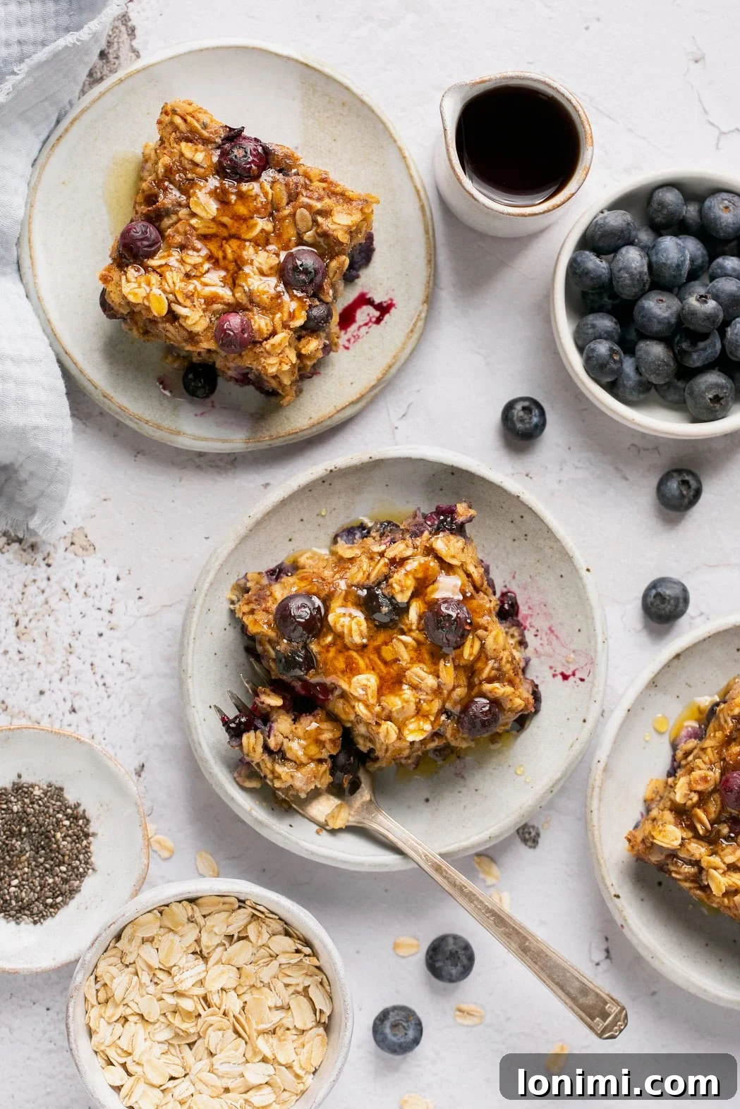 Protein-Packed Vegan Baked Oats 7 an overhead shot of a plate with a slice of baked oatmeal with a fork resting on the side