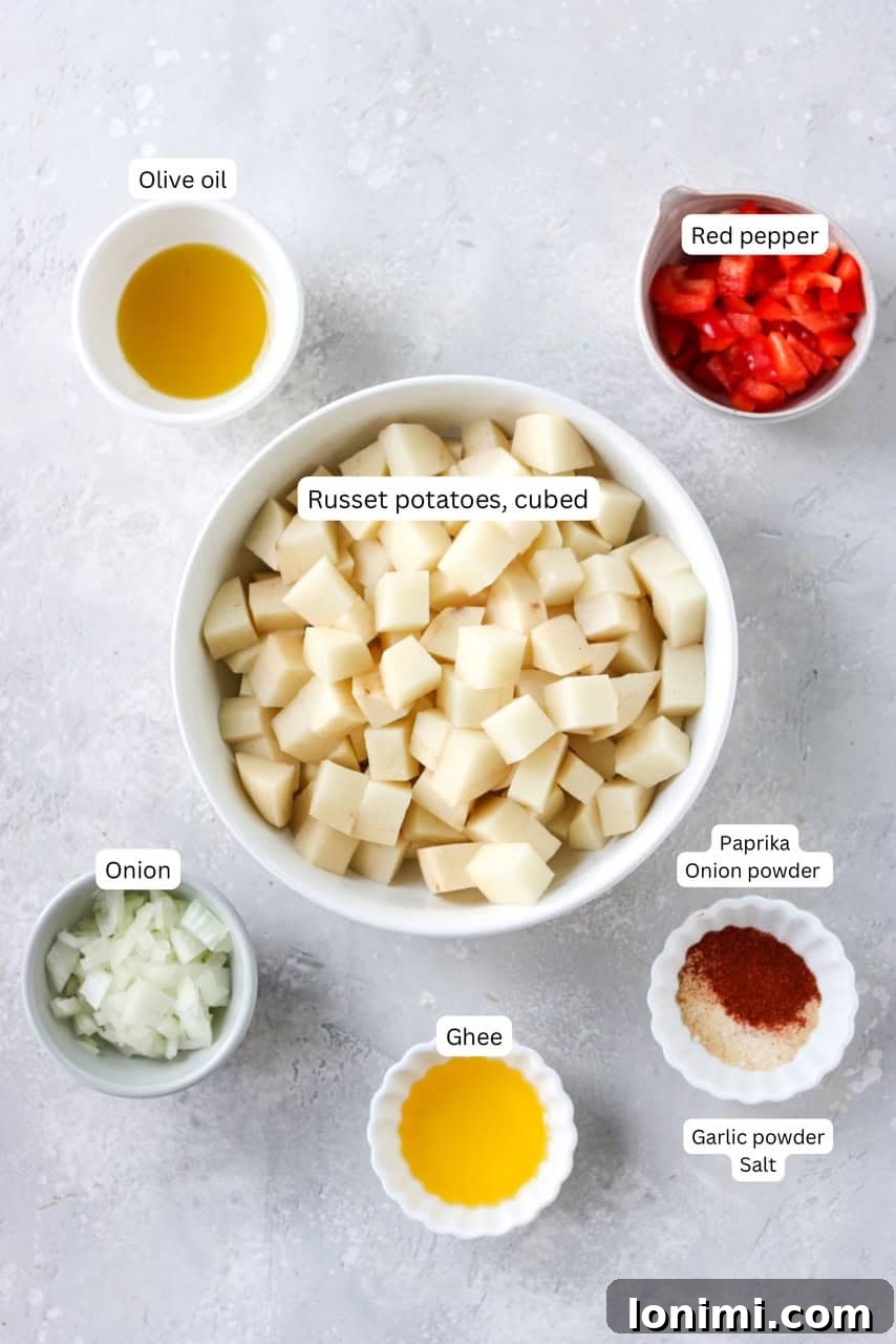 Labeled ingredients for air fryer home fries arranged in nesting bowls.