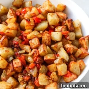 Crispy air fryer home fries in a white bowl