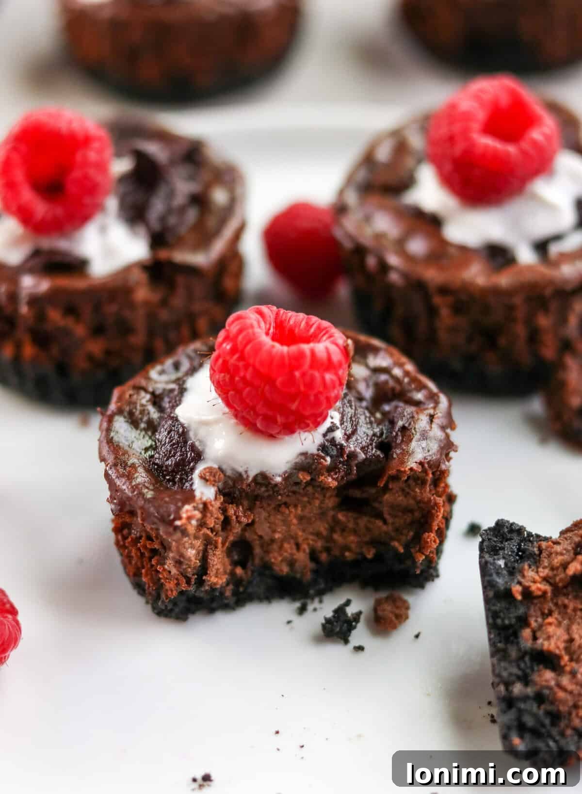 Effortless Chocolate Protein Cheesecake Bliss 7 a bit taken out of a chocolate cheesecake muffin to show the middle