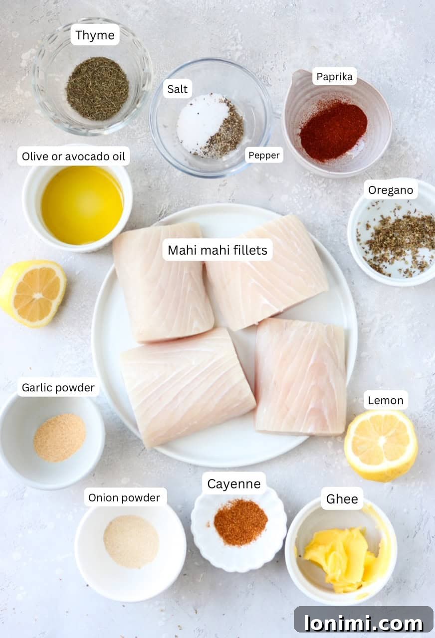 A curated collection of fresh ingredients for blackened mahi mahi, neatly arranged in small, labeled bowls. This includes plump mahi mahi fillets, golden ghee, clear avocado oil, and an array of vibrant spices like garlic powder, onion powder, paprika, oregano, thyme, and cayenne pepper, alongside salt and black pepper.