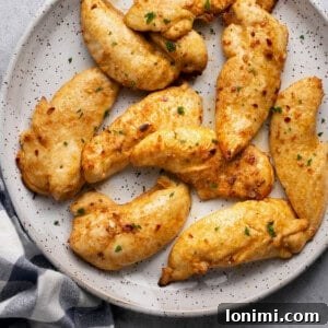 air fryer chicken tenderloins on a plate with a black and white checkered napkin underneath