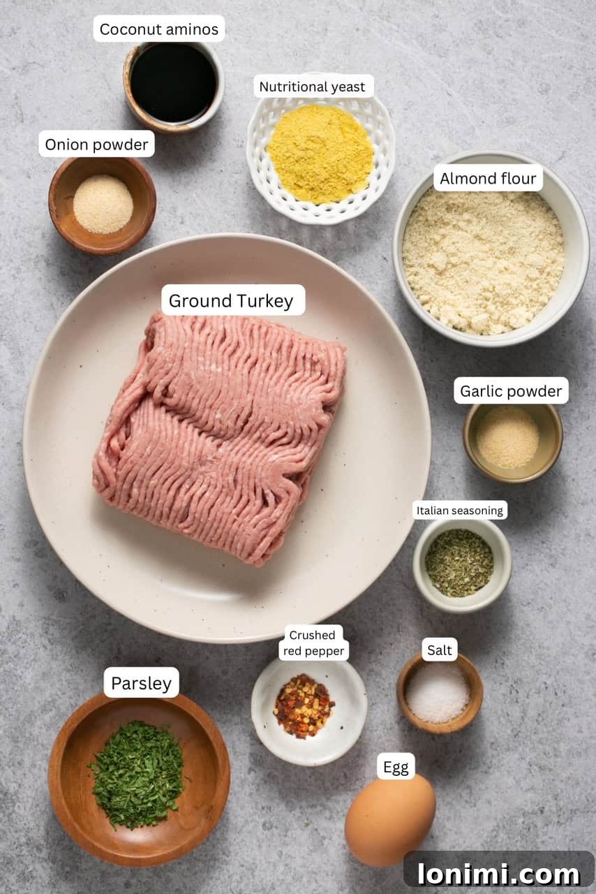 Ingredients for gluten-free turkey meatballs neatly arranged in bowls and on a plate