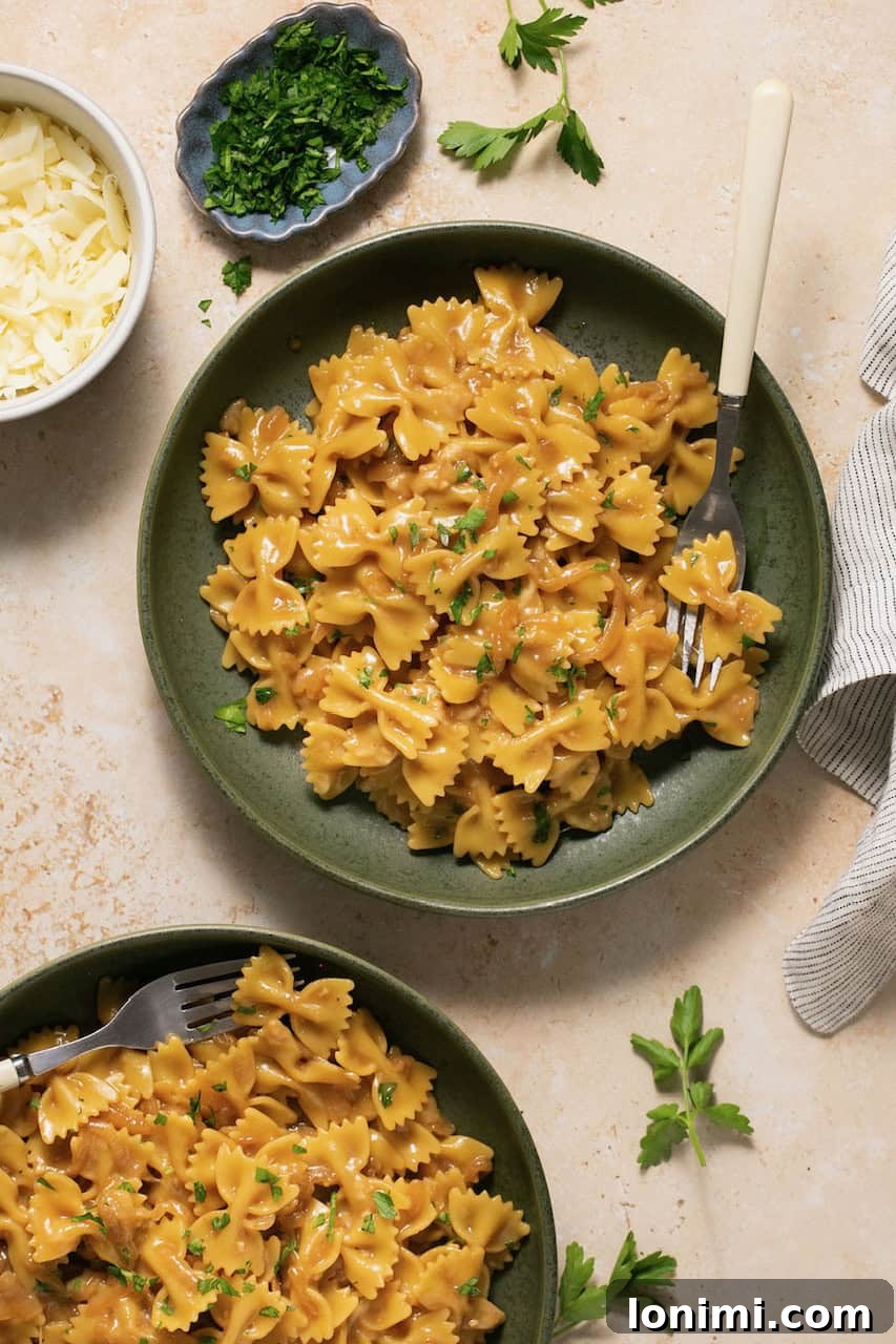 Gluten Free French Onion Pasta The TikTok Sensation 7 An overhead shot of a vibrant green bowl filled with gluten-free French onion pasta, with a fork resting casually on the side, inviting a taste.