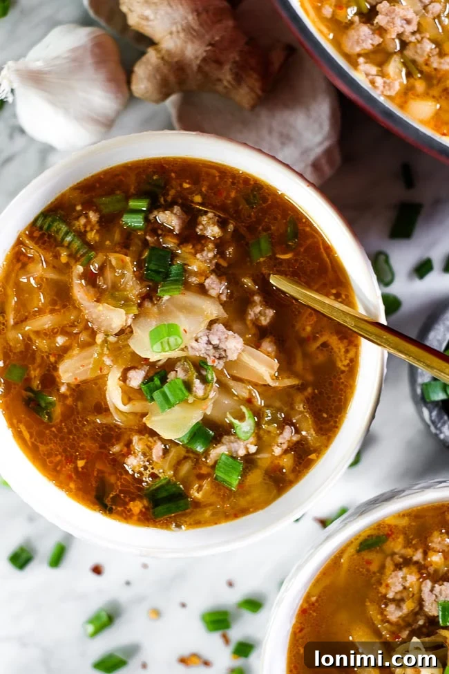 Vibrant bowl of Whole30 Kimchi Soup, garnished with fresh herbs and a hint of spice.