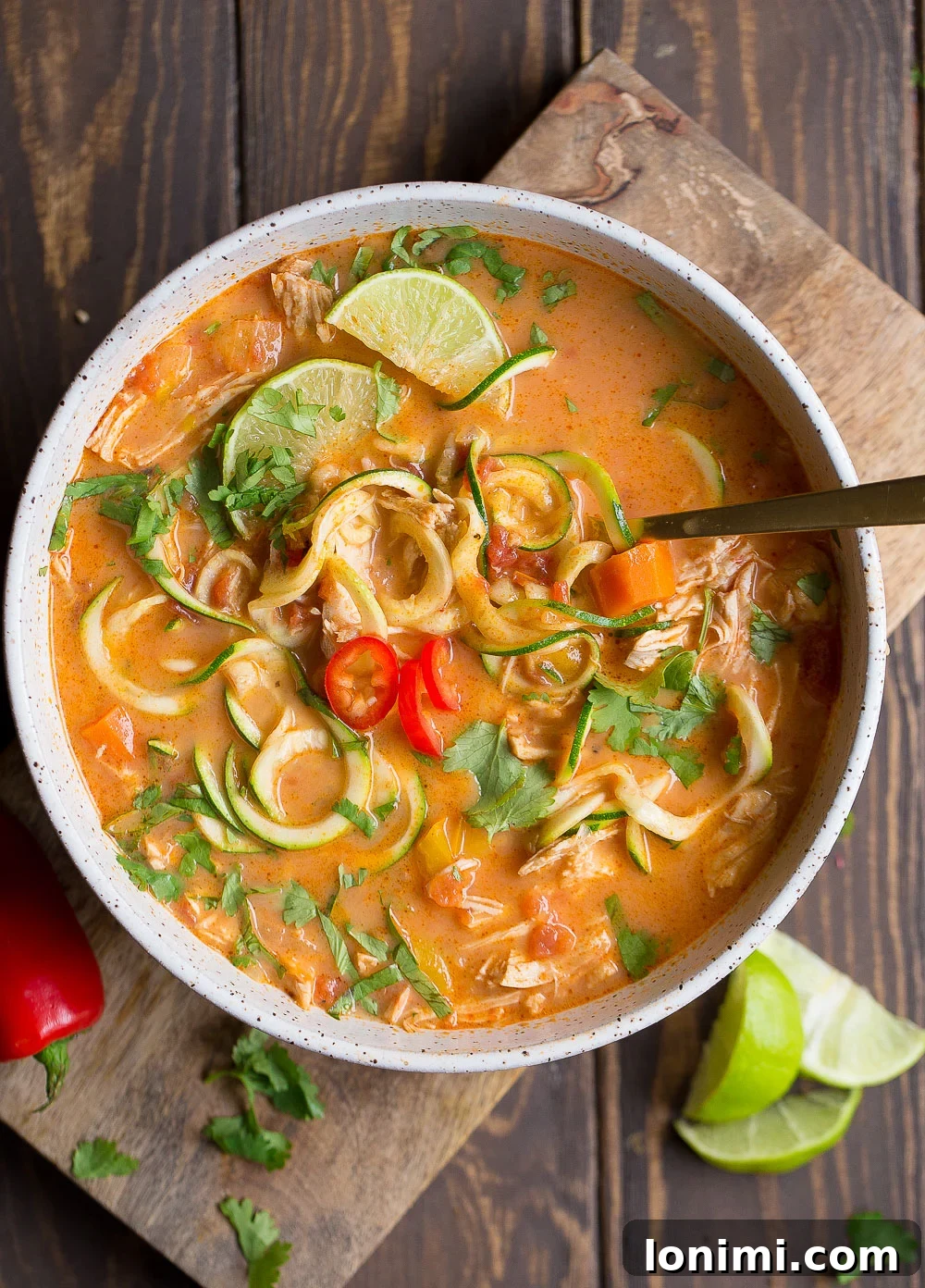 Exotic and fragrant Whole30 Thai Chicken Zoodle Soup with colorful vegetables and chicken.