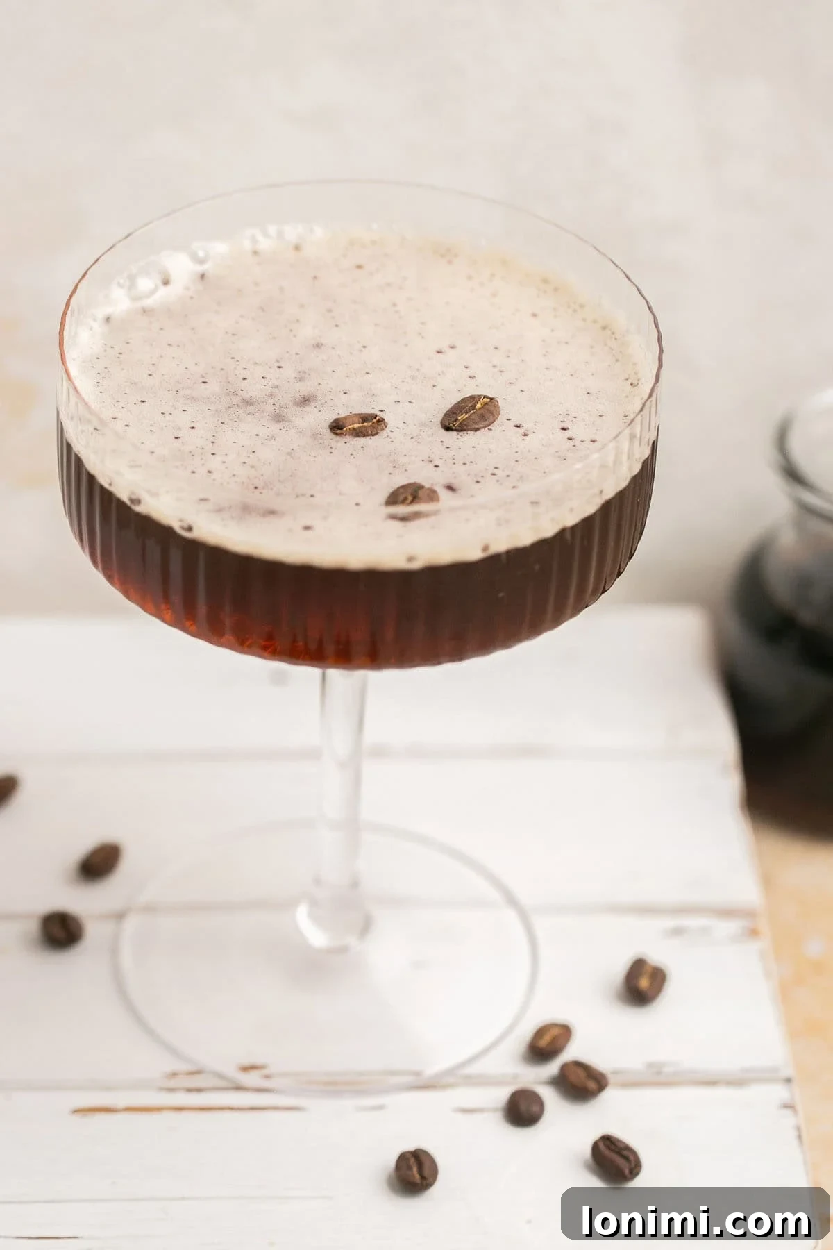 Espresso Martini Perfection The Kahlua Secret 7 a close-up of an espresso martini surrounded by coffee beans