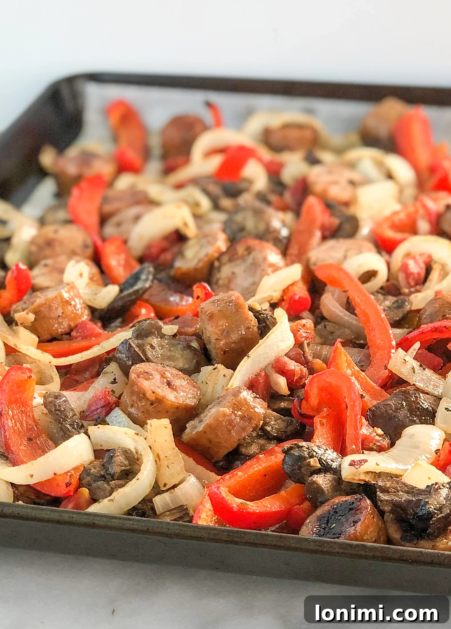 Close-up of cooked Sheet Pan Italian Sausage and Peppers