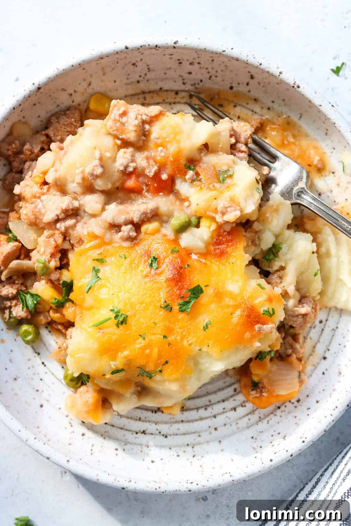 ground turkey shepherd's pie in a bowl with a fork