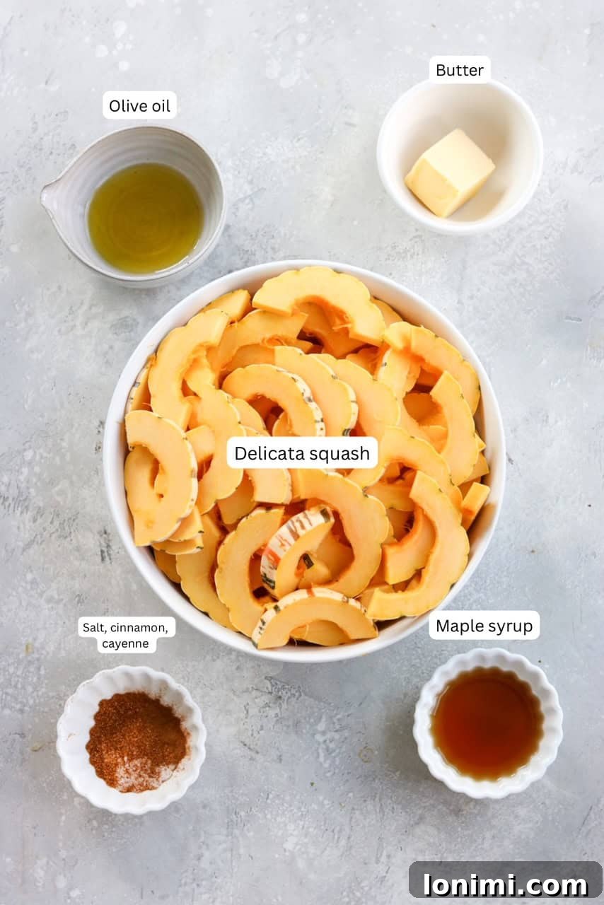 A vibrant collection of ingredients laid out on a countertop, including fresh delicata squash, olive oil, butter, maple syrup, cinnamon, and cayenne pepper, ready for the sautéing process.