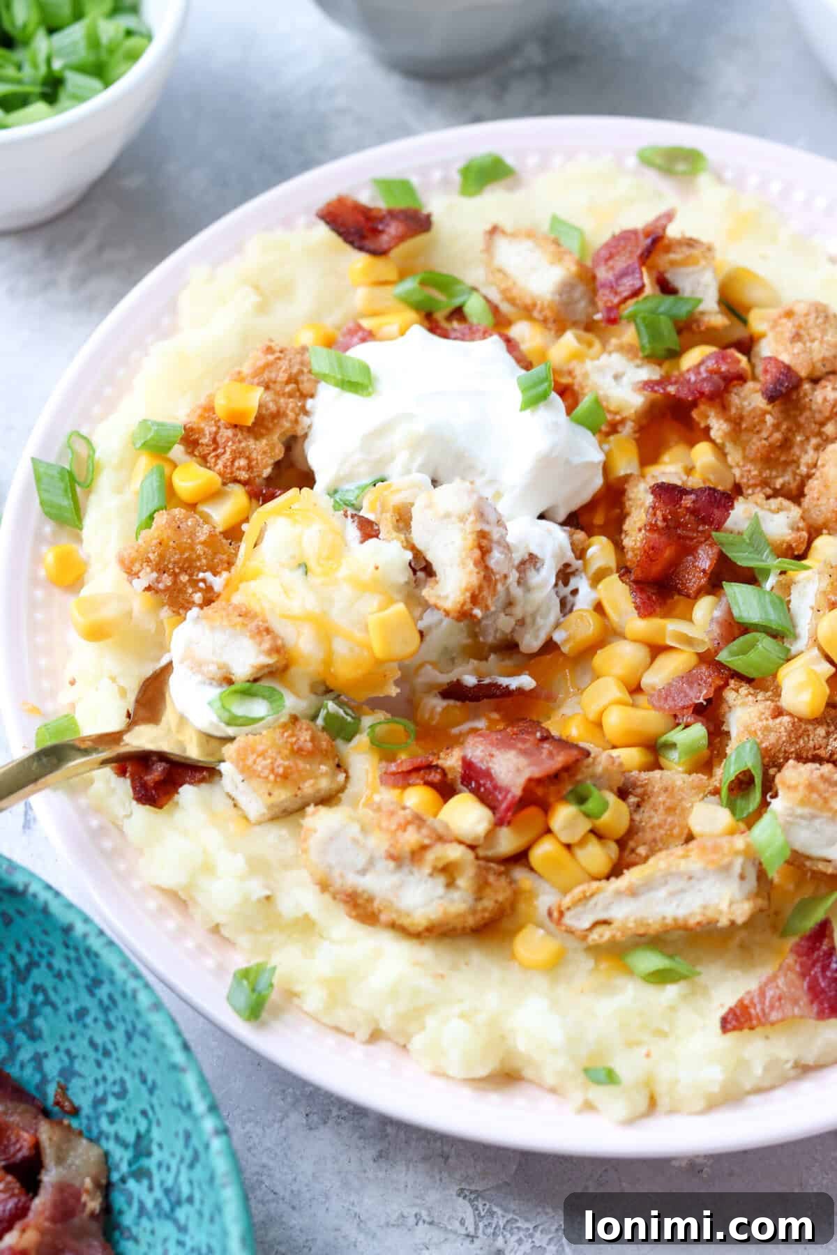 Ultimate Mashed Potato Bowls 8 a fork scooping up a bite of a loaded potato bowl