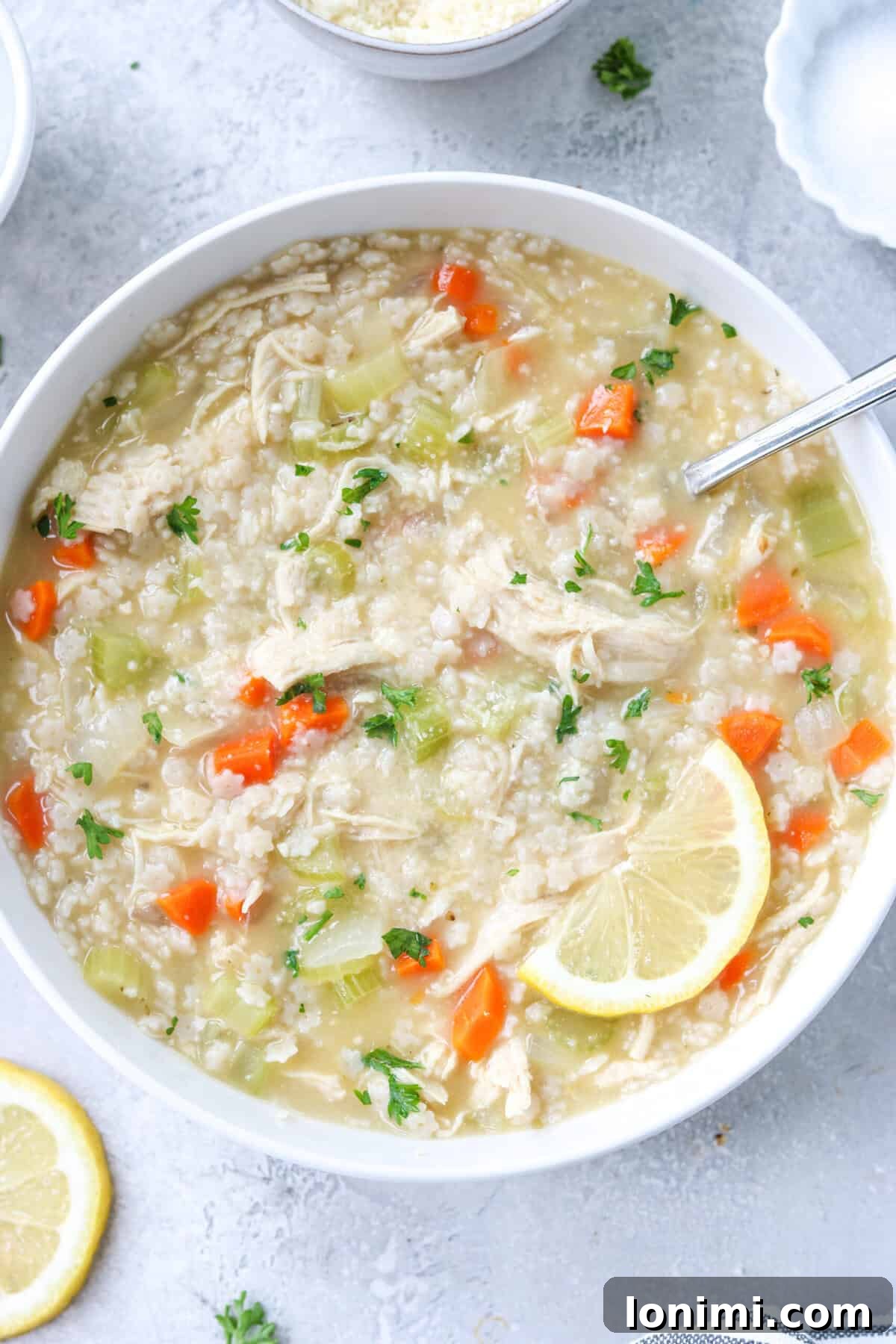 Comforting Gluten-Free Chicken Pastina Soup 6 gluten free chicken pastina soup in a bowl topped with parsley and parmesan and a slice of lemon