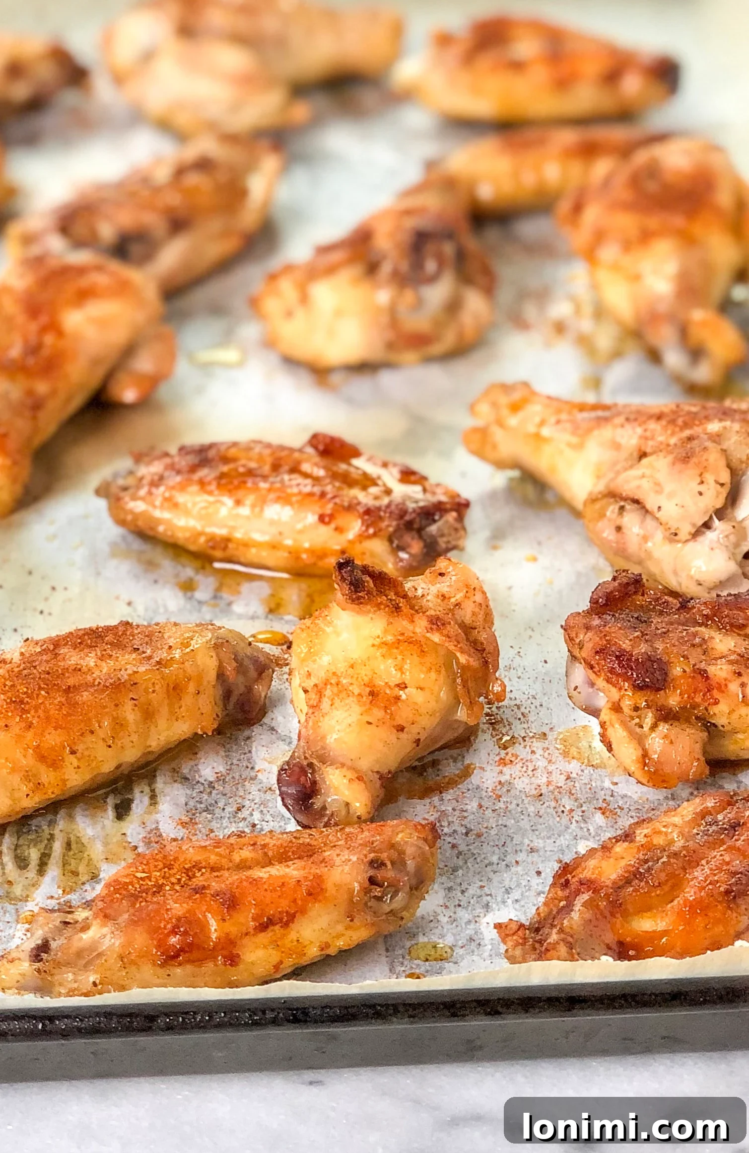 Paleo Whole30 Old Bay Wings 2 Crispy Paleo Old Bay wings on a baking sheet
