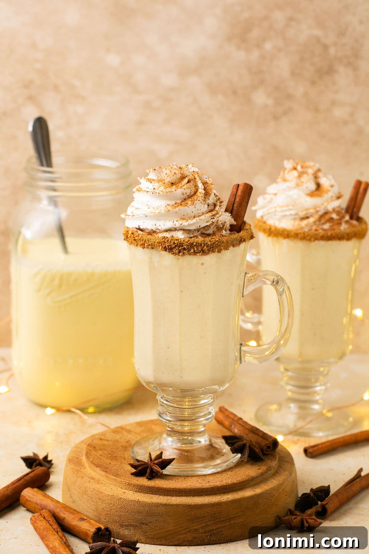 A festive glass of dairy-free eggnog, rimmed with cinnamon sugar, ready for the holidays.