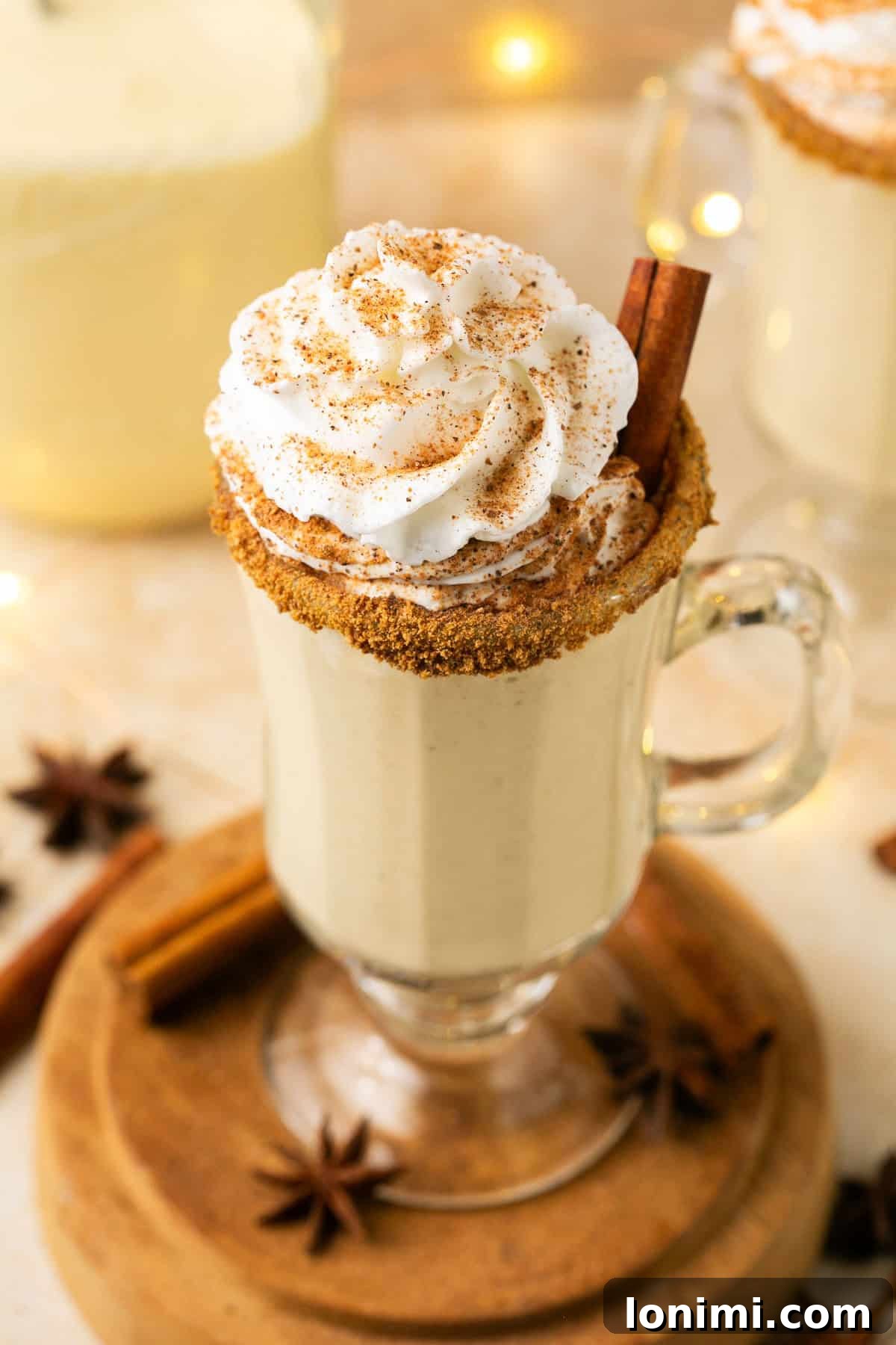 A perfectly garnished cup of eggnog with whipped cream, ready to be enjoyed as a festive holiday drink.