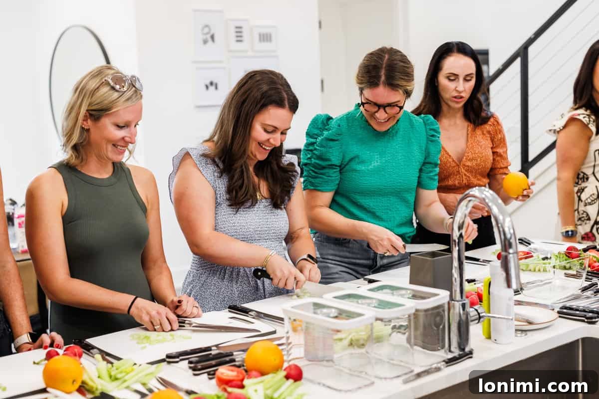 Bloggers intently participating in a knife skills class taught by a Zwilling chef at the retreat, learning culinary techniques.