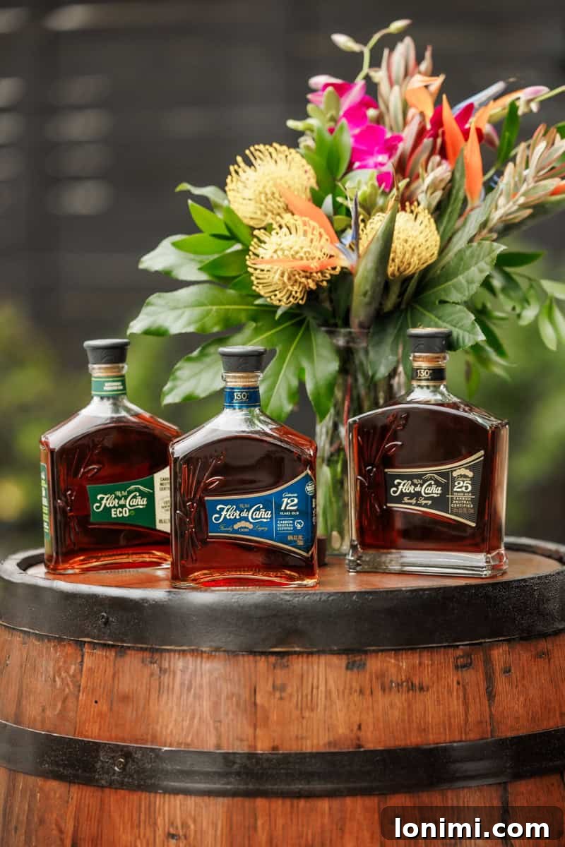 An array of Flor de Caña rums displayed elegantly on a wooden barrel, highlighting their premium collection.