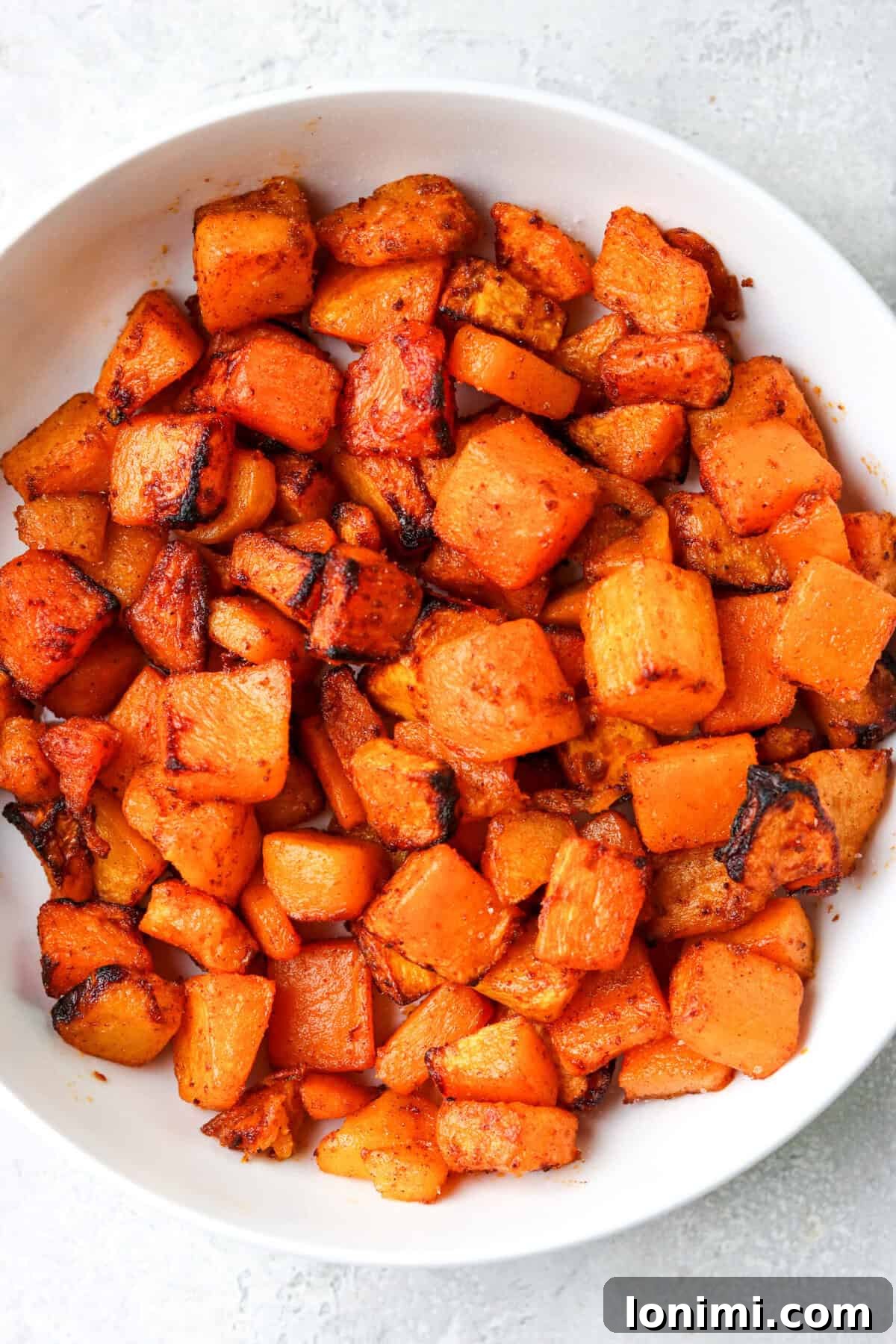air fryer butternut squash in a white bowl